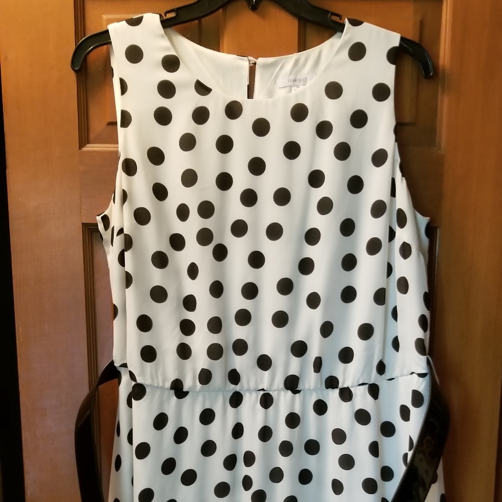 White sleeveless dress with black polka dots
